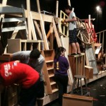 Students build a barricade for Les Miserables